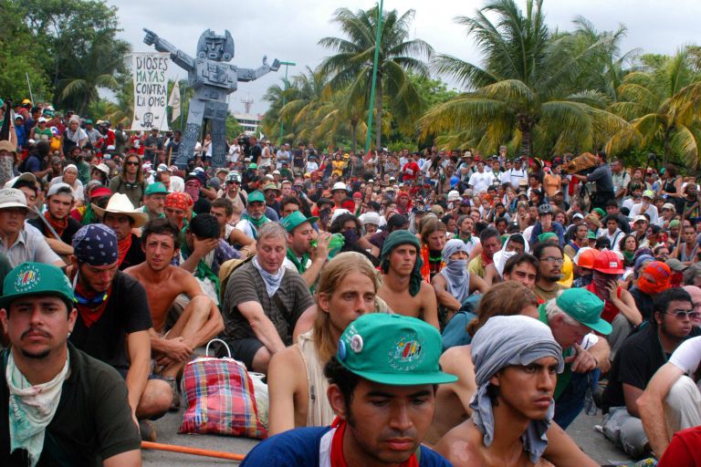 Globalisierungskritischer Protest während des WTO-Treffens im mexikanischen Cancún 2003, viele Menschen sitzen auf der Straße 